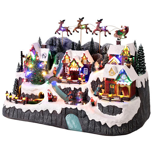 Villaggetto di montagna con ruscello e pattinatori animati luci e musica 60x35x40 cm 3