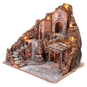 Nativity village with central fountain, left staircase 40x45x45 lighted 6-8-10 cm