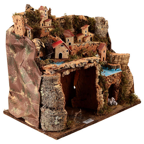 Borgo illuminato su montagna con grotta e fienile presepe 9 cm 3
