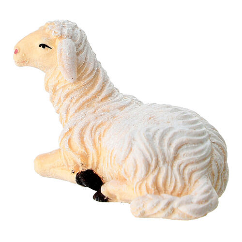 Lying sheep looking to its left in painted wood from Valgardena for Rainell Nativity Scene 9 cm 2