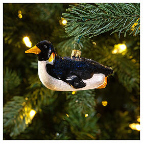 Blown glass Christmas ornament, penguin sledding