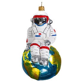 Astronaut sitting on Earth Christmas tree ornament in blown glass