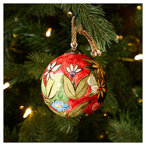 Dellarte Ceramiche hand-painted Christmas tree decoration with colourful floral pattern on red background, 3 in 2