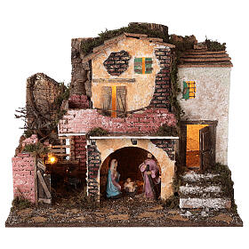 Village with masonry porch, lights and fire 40x45x30 cm with 10 cm Holy Family