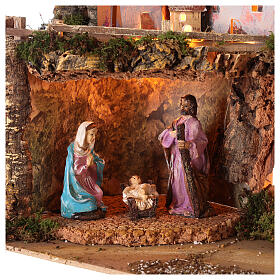 Nativity village 50x25x35 cm with lights and Holy Family 10 cm