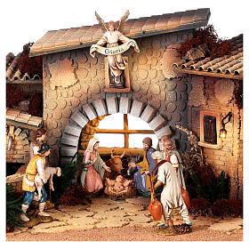 Presépio completo aldeia clássica com fontanário e mesa cheia figuras presépio Moranduzzo altura média 12 cm; medidas: 35x100x45 cm