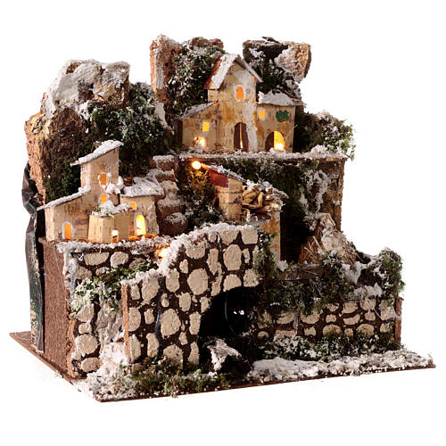 Snow-covered multi-story village with lights 25x25x20 cm 3