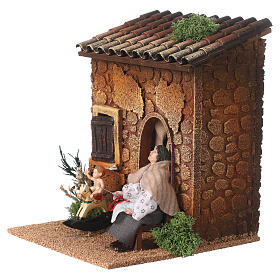 Woman embroidering and child on a rocking horse, animated Nativity Scene of 10 cm, 20x15x15 cm