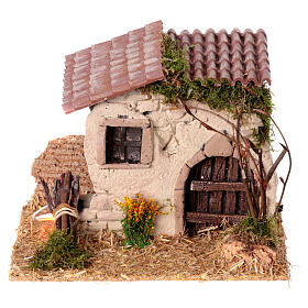 Miniature rustic house 15x20x15cm with flickering fire, 6cm nativity scene