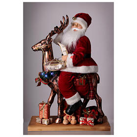 Père Noël avec elfe traineau lumières mouvement musique 55x80x20 cm