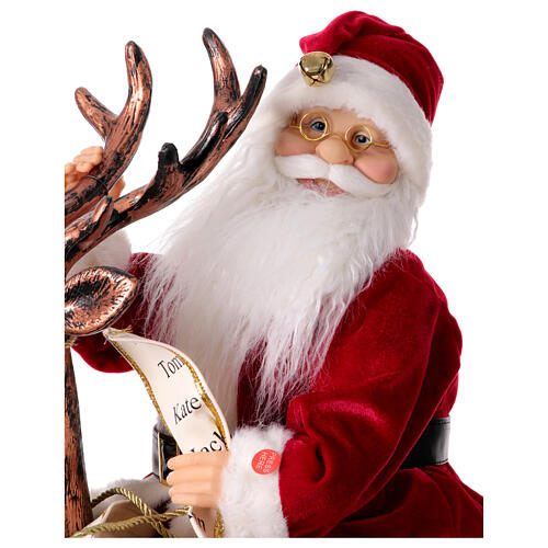 Babbo Natale con elfo slitta luci movimento musica 55x80x20 cm 3