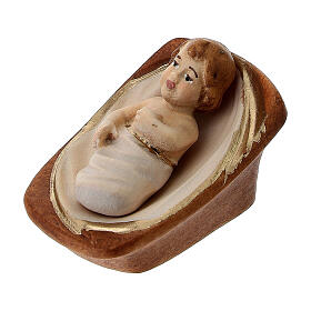 Baby Jesus figurine in manger, colored Val Gardena nativity