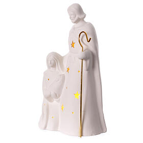 Nativity Holy Family in porcelain warm light stars golden staff 25x15x5 cm