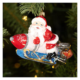 Santa Claus on a rocket blown glass Christmas ornament, height 13.5 cm