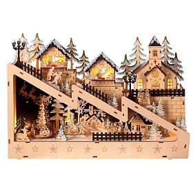 Pueblo navideño ladera nevada iglesia madera luces movimiento 30x45x10 cm