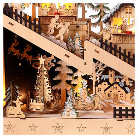 Village Noël pente enneigée église bois lumières mouvement 30x45x10 cm