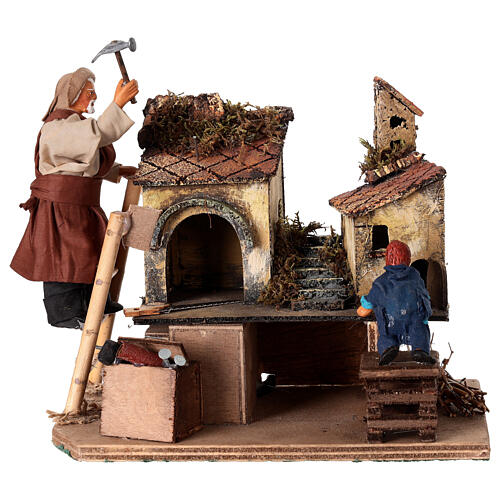 Homme animé construisant une crèche avec un enfant crèche napolitaine 12 cm 1