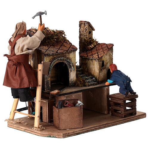 Homme animé construisant une crèche avec un enfant crèche napolitaine 12 cm 4