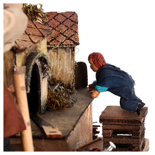 Homme animé construisant une crèche avec un enfant crèche napolitaine 12 cm 5