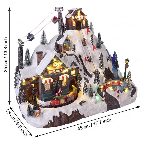 Pueblo navideño iluminado 35x45x25 cm movimiento esquiadores montaña tren 3