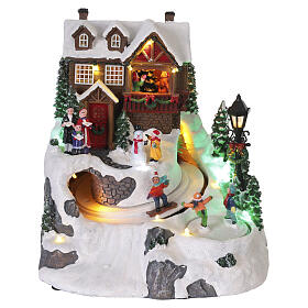 Villaggio natalizio animato pista da sci bambini 25x20x23 cm LED multicolor e musica