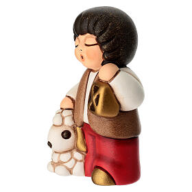 Child with ceramic lantern in red THUN Classic Nativity Scene