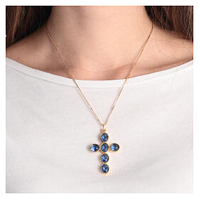 Cross-shaped pendant with zamak settings and blue oval crystals