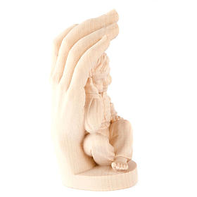 Hand of God with baby boy in wood