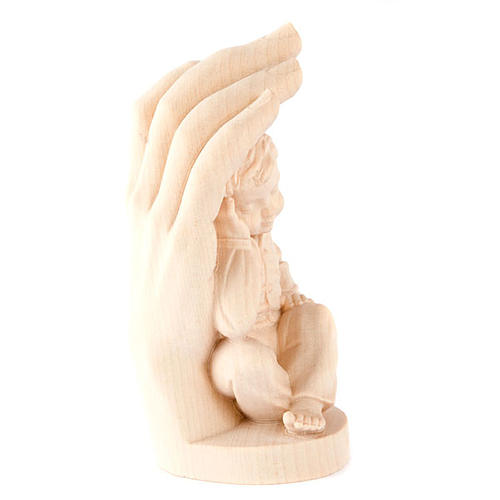 Hand of God with baby boy in wood 2