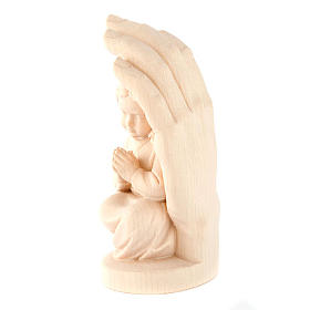 Hand of God with baby girl in wood