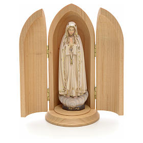 Our Lady of Fatima wooden statue painted in niche