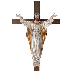 Resurrected Jesus Christ statue in natural wood on cross